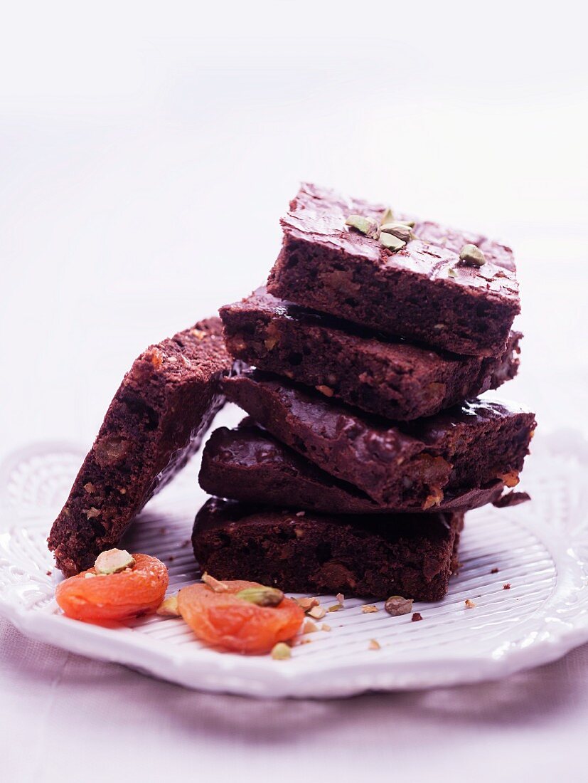 Brownies with pistachios, stacked on a plate
