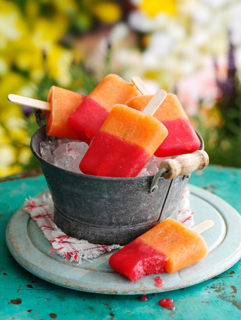 Mixed melon ice lollies in an ice bucket