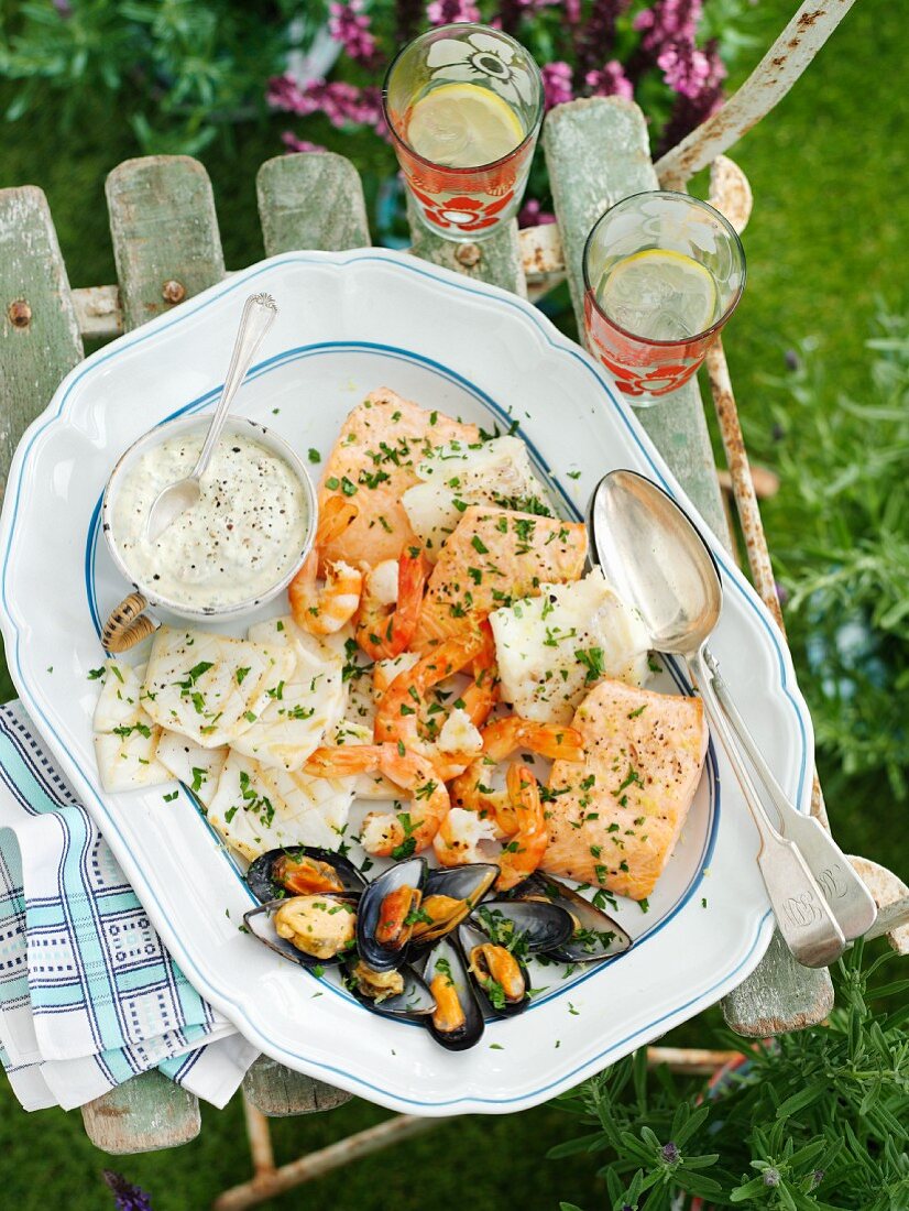 A mixed grill plate with fish, seafood and herb mayo