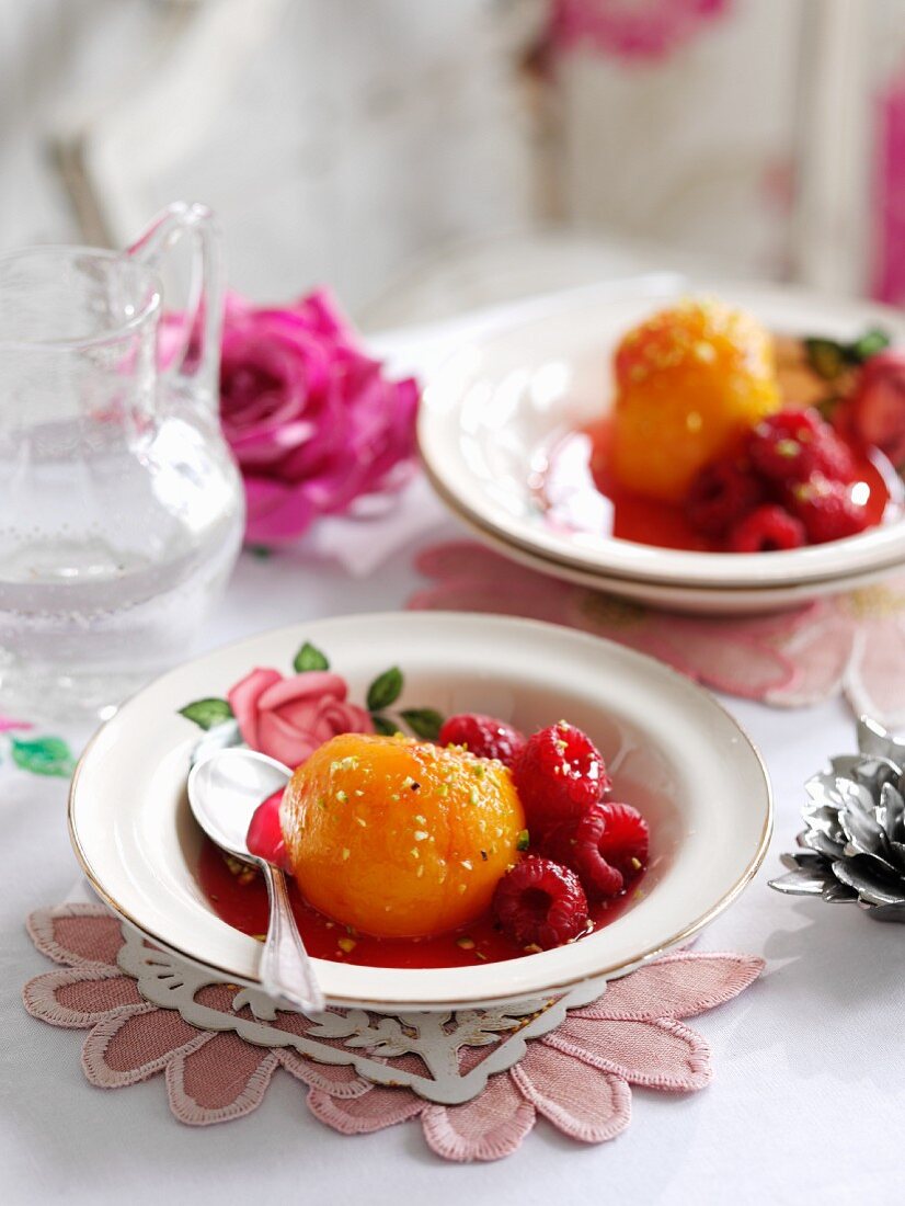 Poached peaches with rose water, pistachios and raspberries