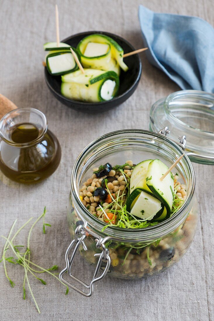 Israeli couscous with zucchini and halloumi in a glass jar