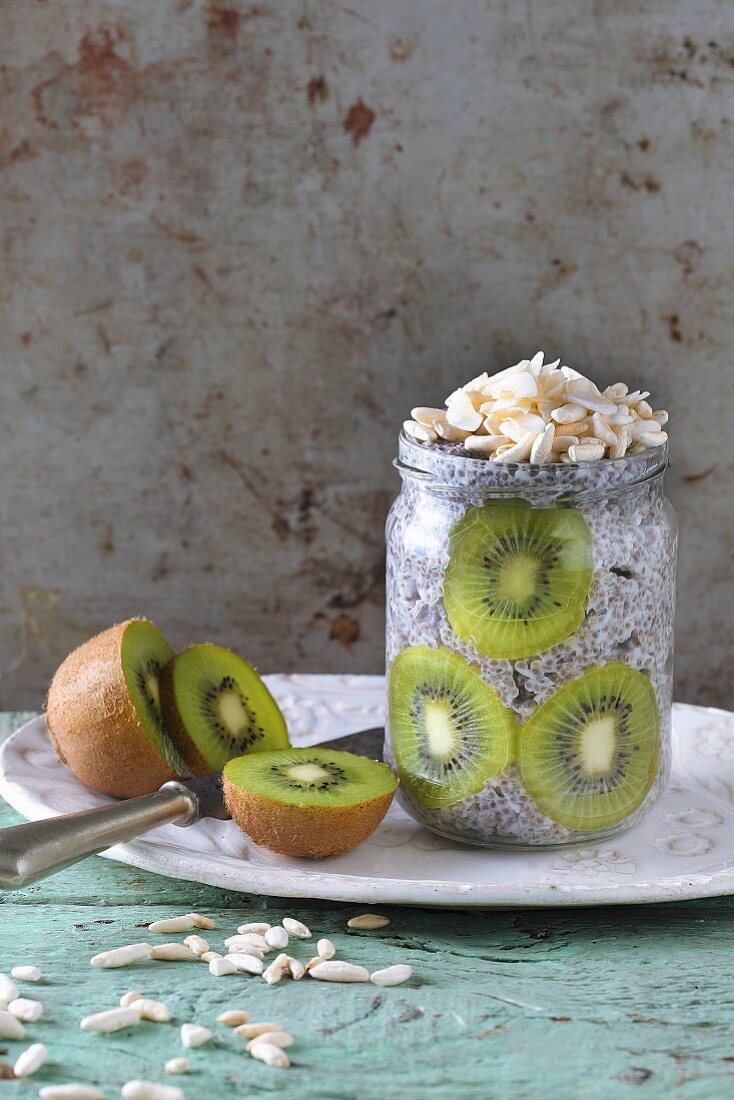 Chia pudding with kiwi and almonds in a glass jar