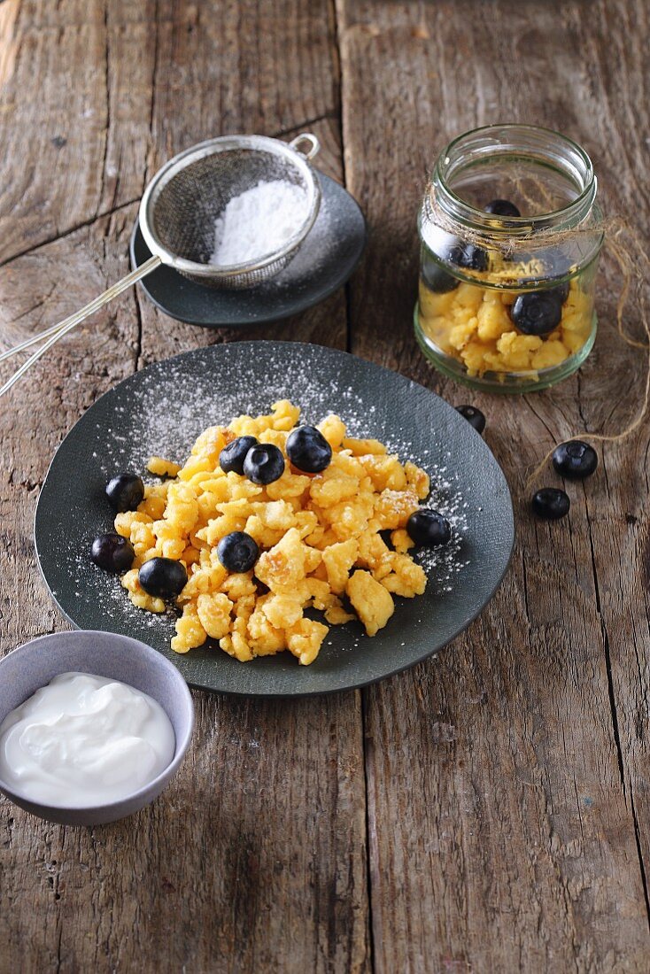 Kaiserschmarren (shredded pancakes) with blueberries and icing sugar