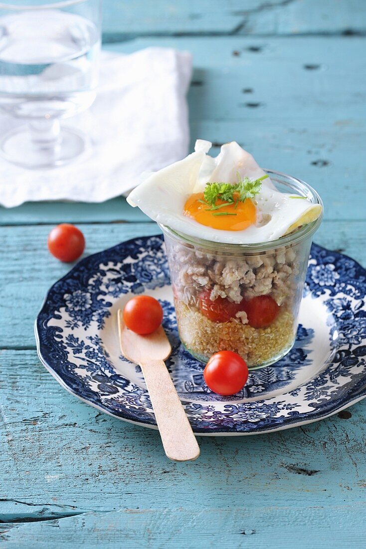 Quinoa salad with cherry tomatoes and fried egg