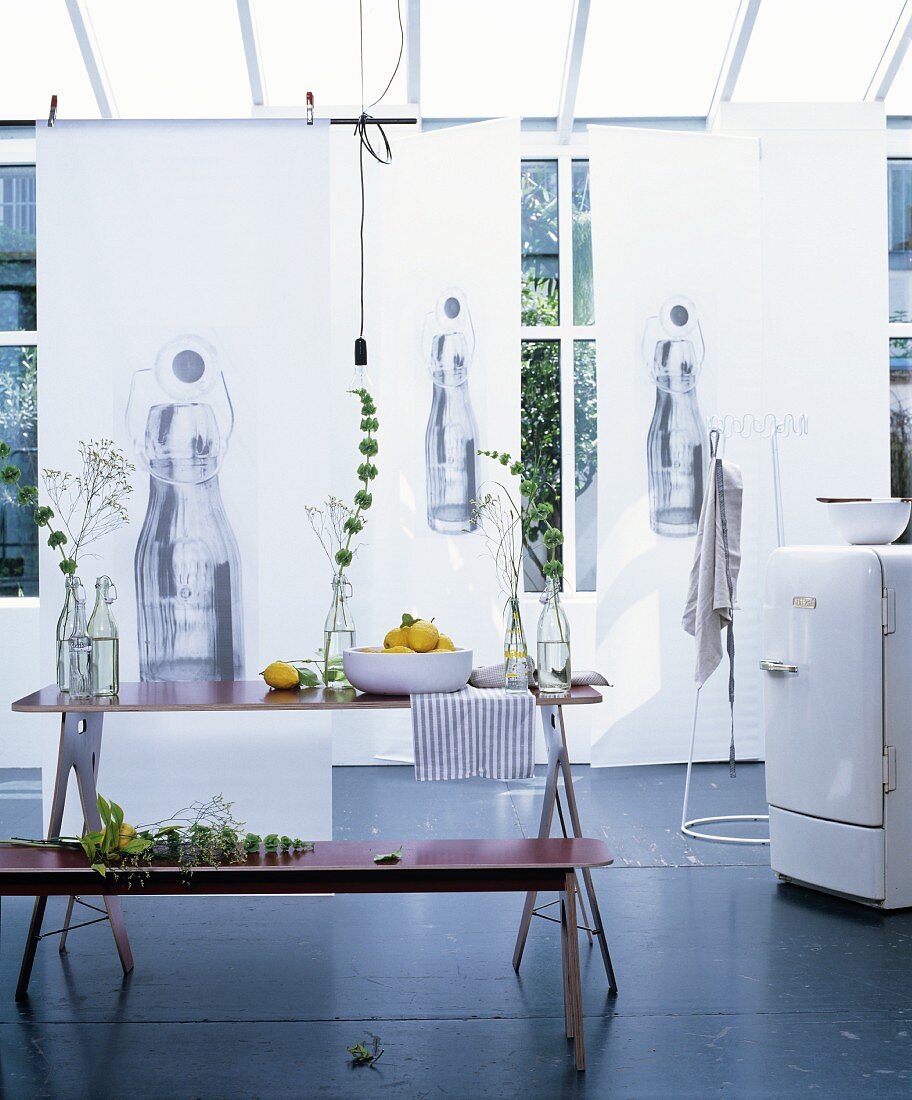 Printed paper walls and set table in bright conservatory