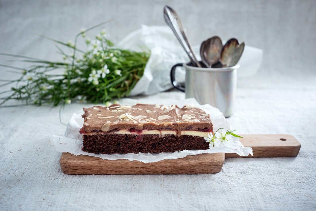 Tray-bake chocolate cake with cherries and vanilla and chocolate cream (vegan)