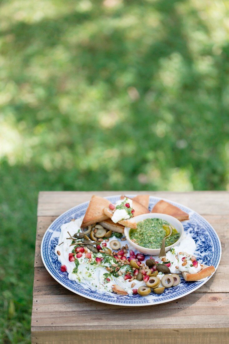 Garlic and lemon labneh with salsa verde and roasted pita bread corners