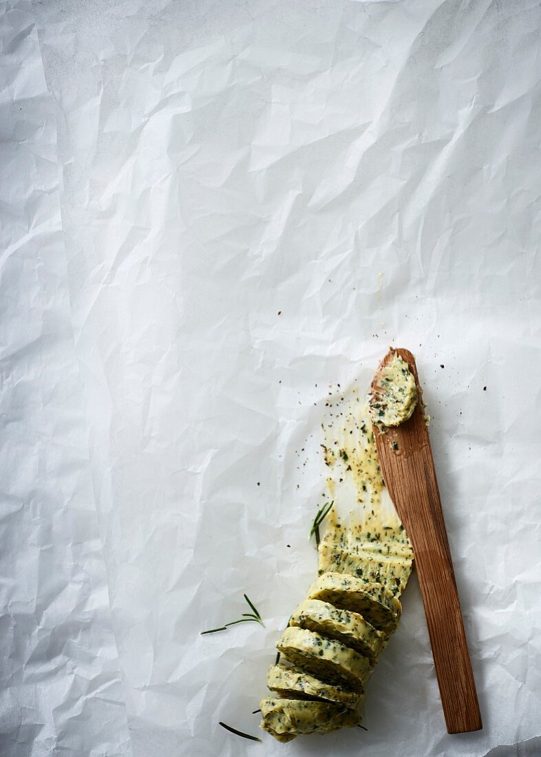 Herb butter with a wooden knife