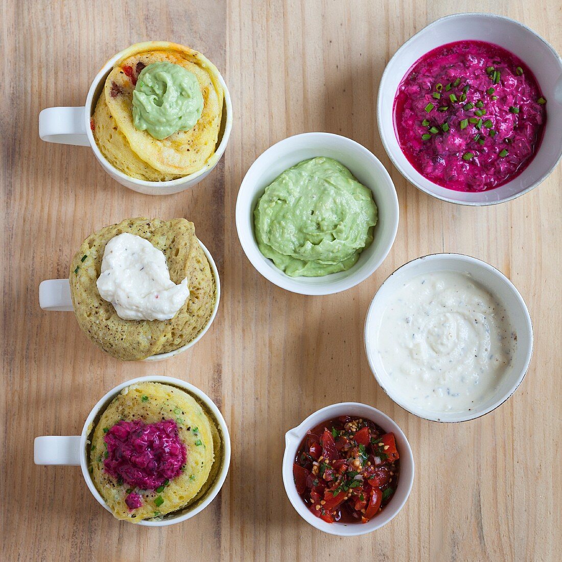 Mug cakes with different dips as a topping (seen from above)