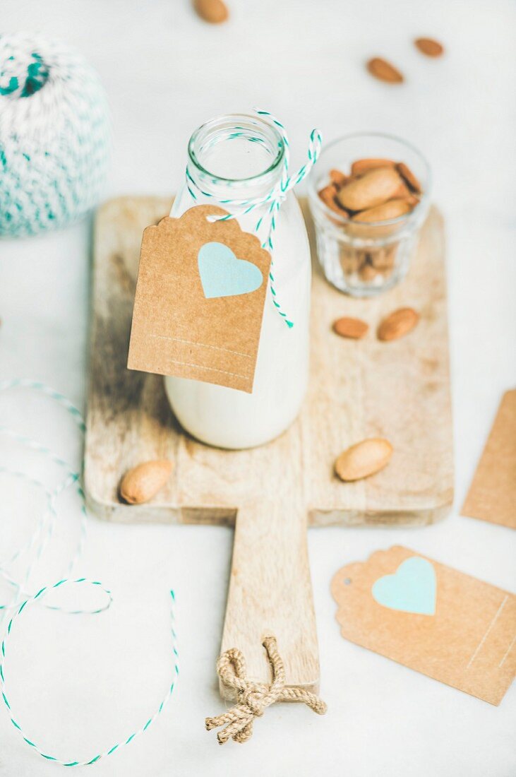 Fresh vegan dairy-free almond milk in glass bottle with craft paper label