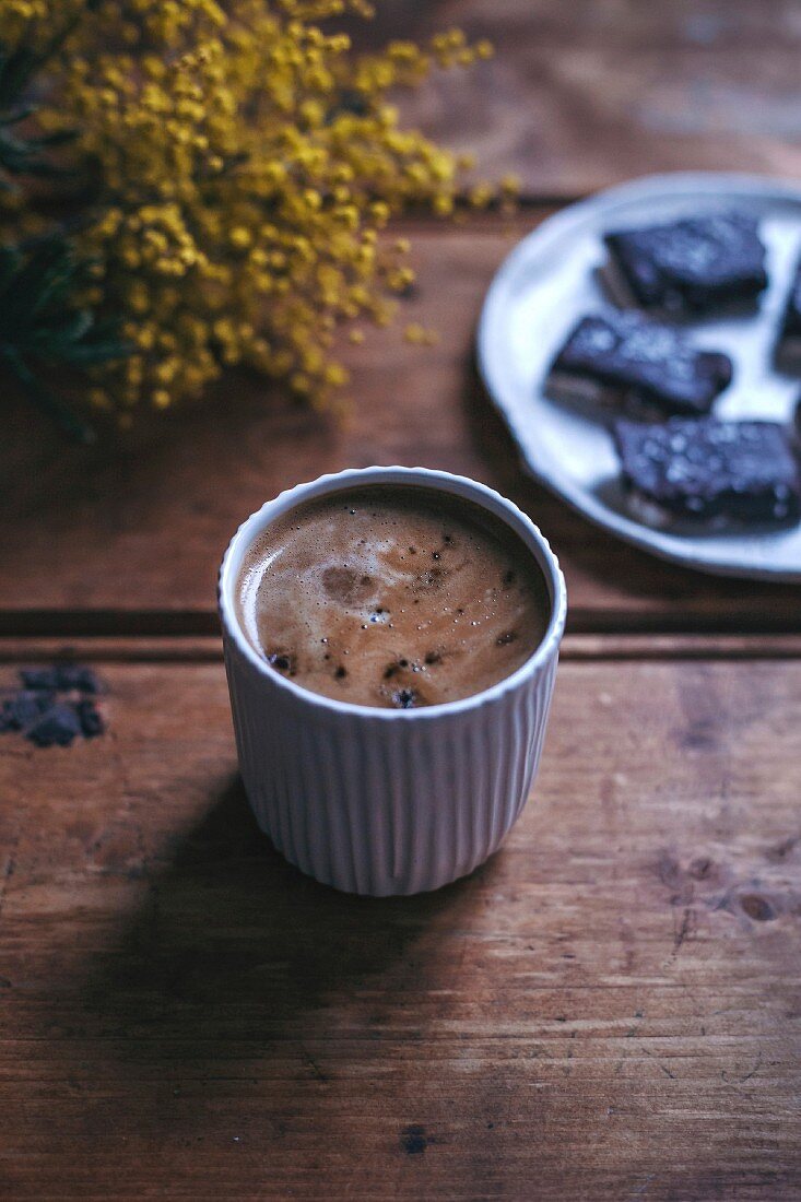 Cup of black coffee on a rustic wooden table