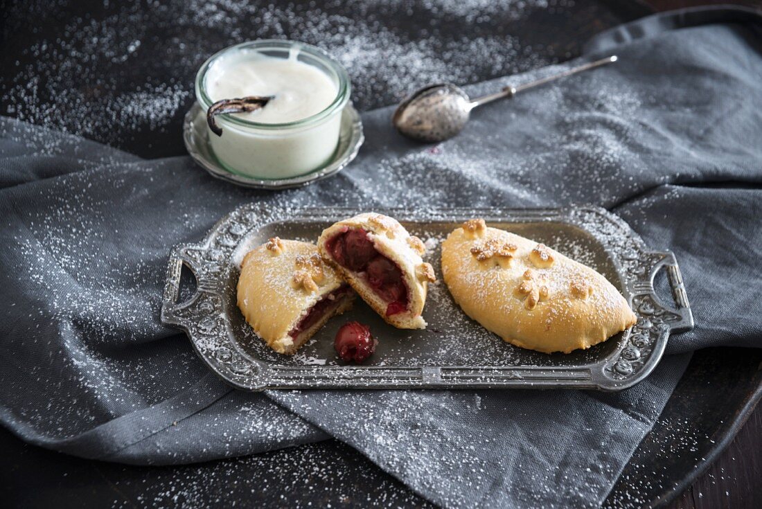 A vegan yeast pastry filled with sour cherries and vanilla sauce