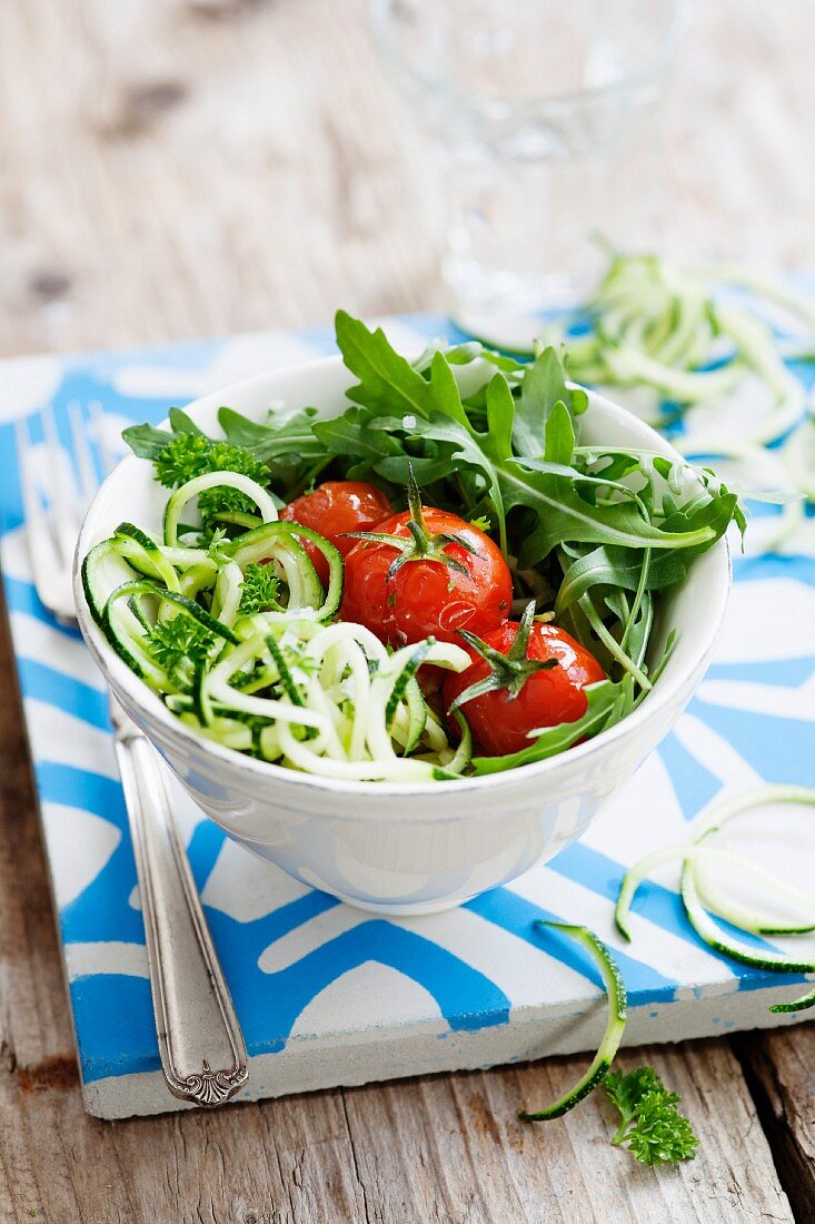 Spiralized courgettes with roasted vine tomatoes and rocket