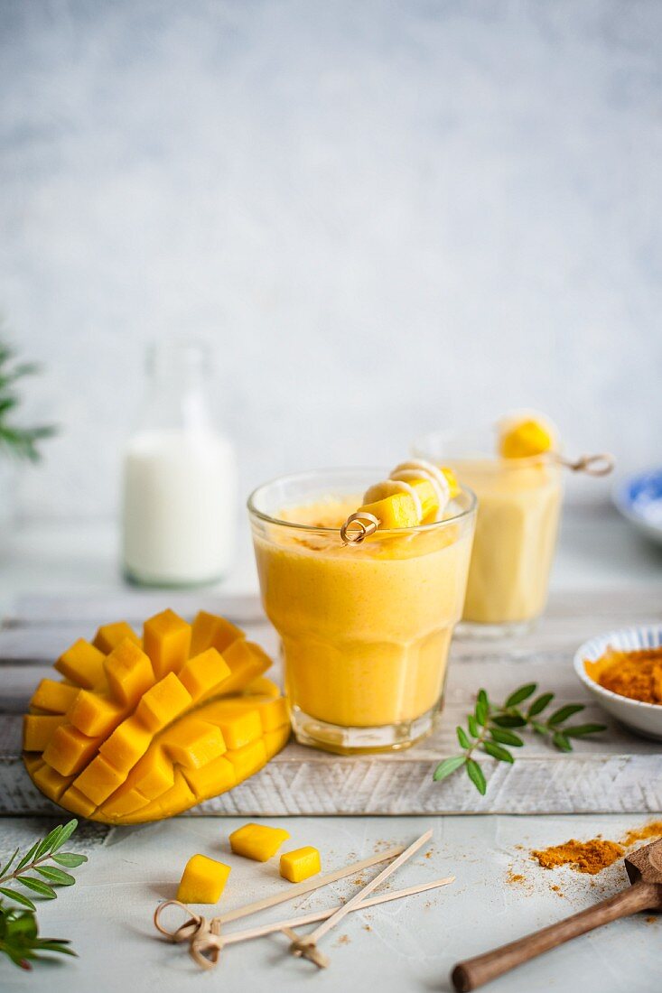 Mango lassi with turmeric and honey, fresh mango on a side