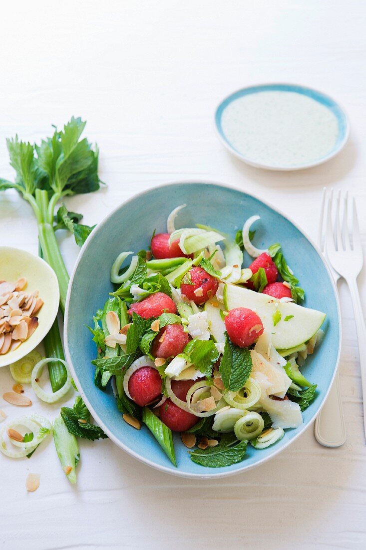Celery and fennel salad with watermelon, almonds, parmesan and avocado dressing