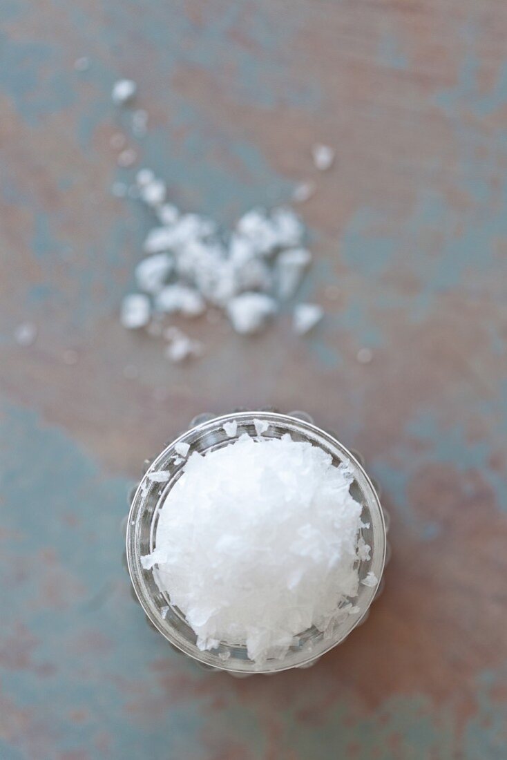 Sea salt flakes in a glass (seen from above)