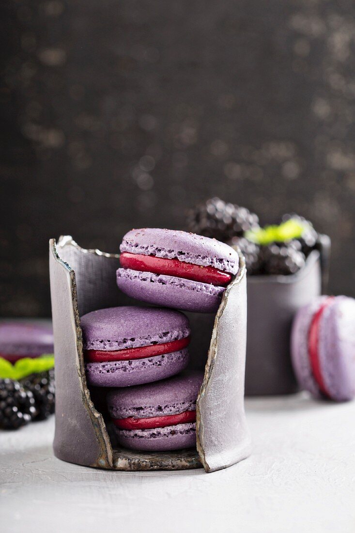French macarons with berry filling on a gray table