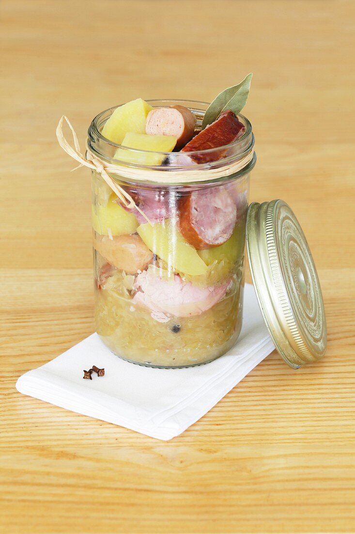 Sauerkraut with sausage and potatoes in a glass jar