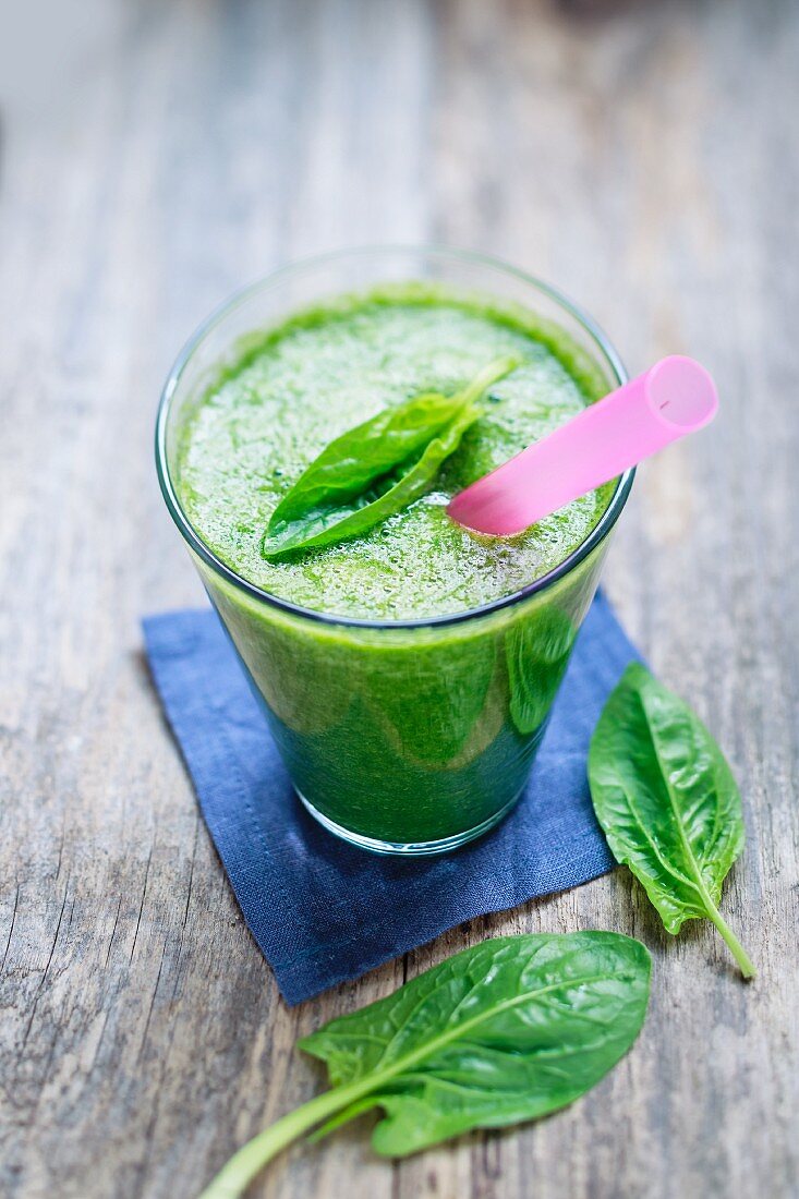 Green spinach smoothie with banana and mango