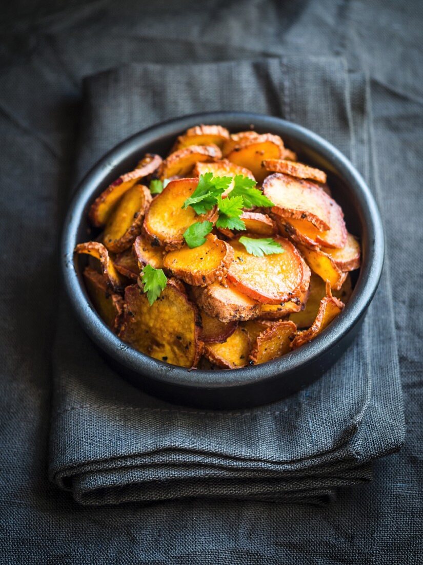 Oven-baked sweet potato slices in a bowl