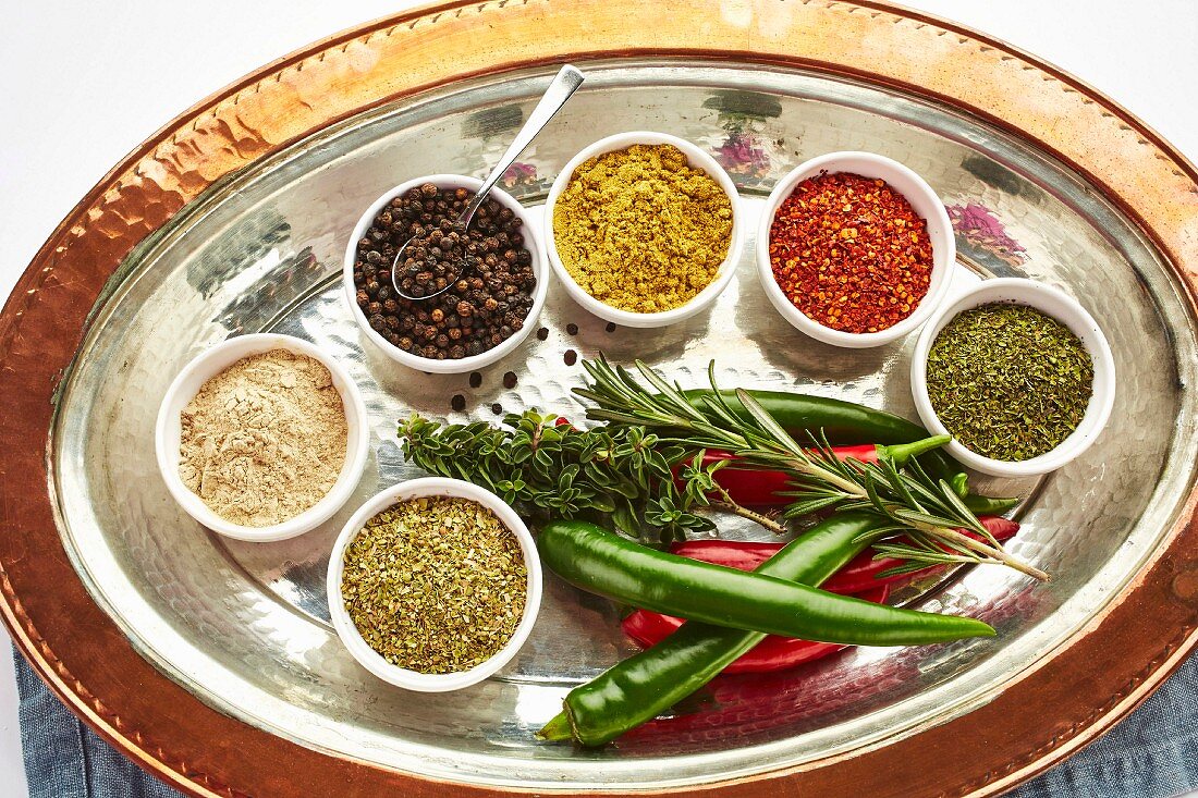 Various Oriental spices in small dishes on a serving platter