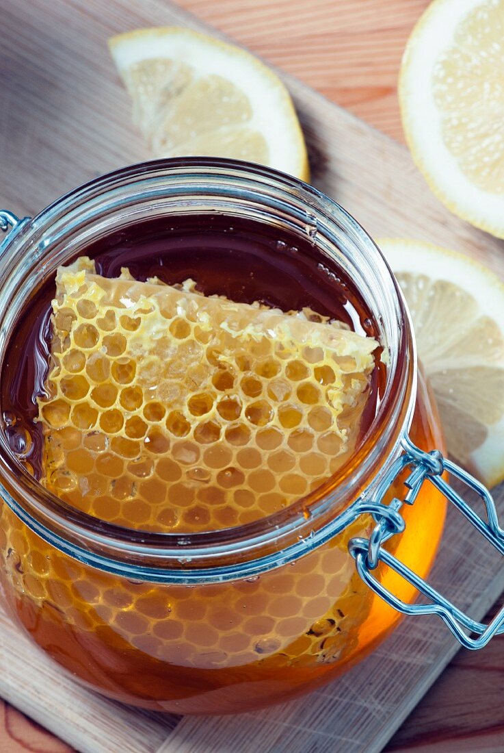 Greek organic honey with honeycomb in a glass jar