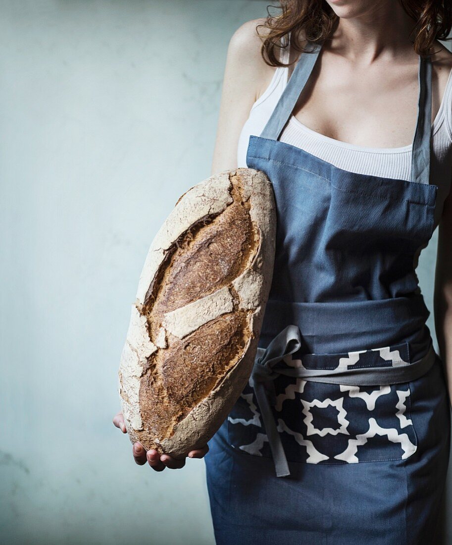 Woman holding a loaf of bread