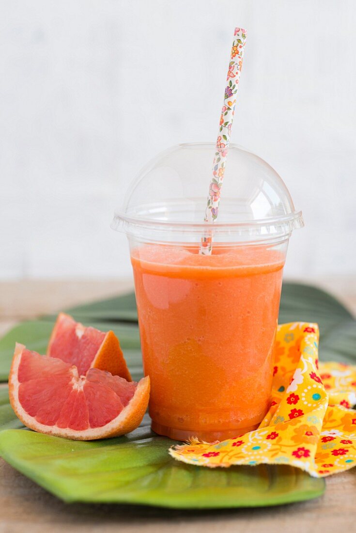 Smoothie with pink grapefruit, carrots, lemon juice and ginger