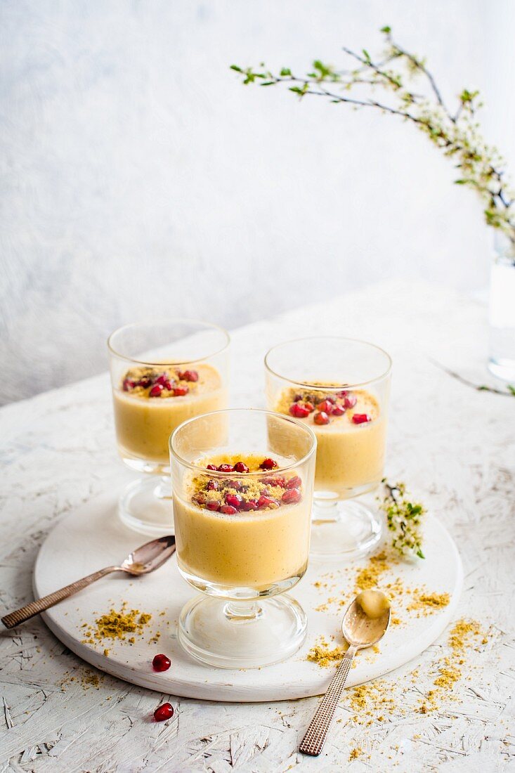 White chocolate sauce with pomegranate seeds and ground pistachios