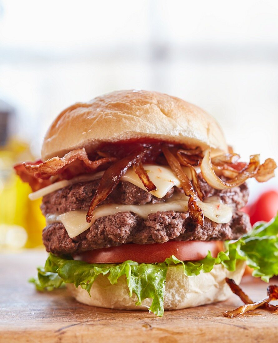 A double burger with cheese, bacon and onions