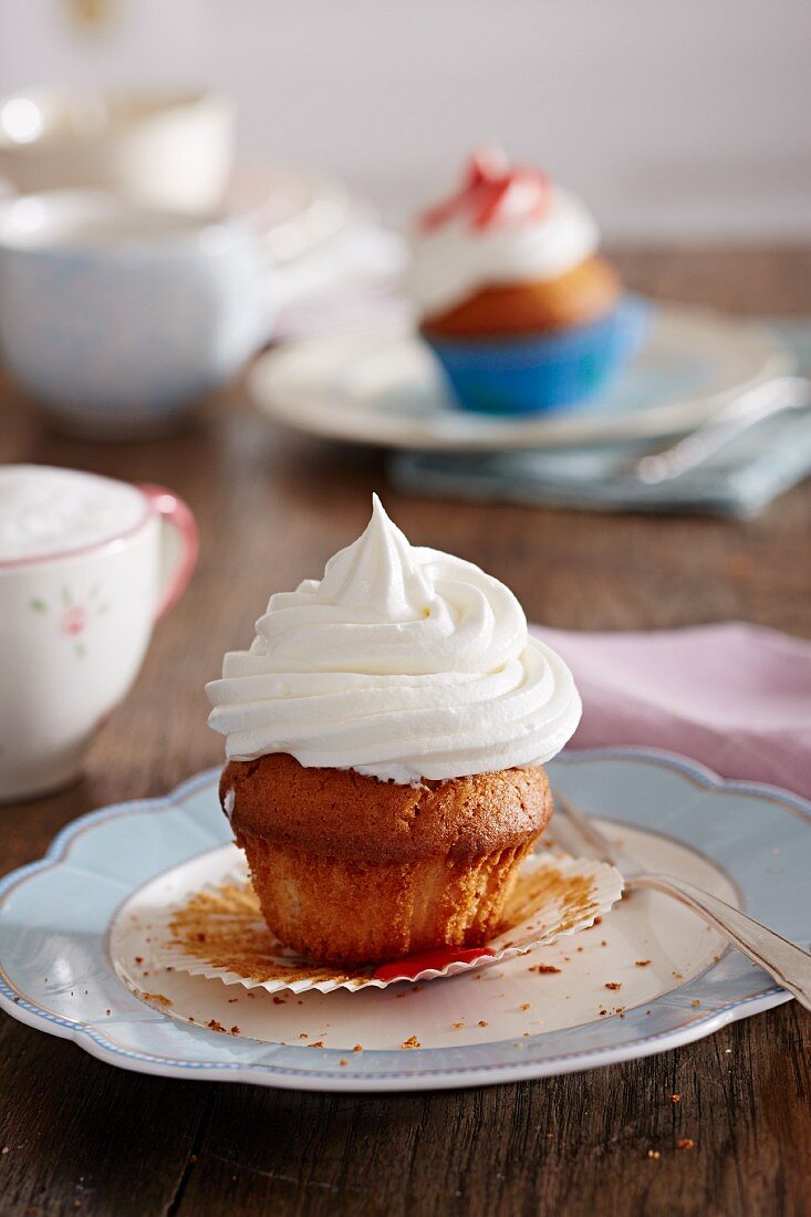 A cupcake with white frosting