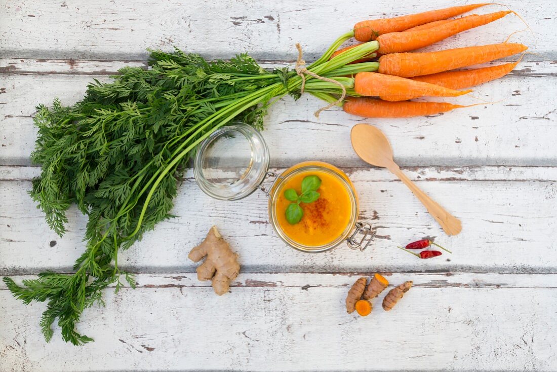 Carrot soup with turmeric, ginger and chilli in a flip-top jar