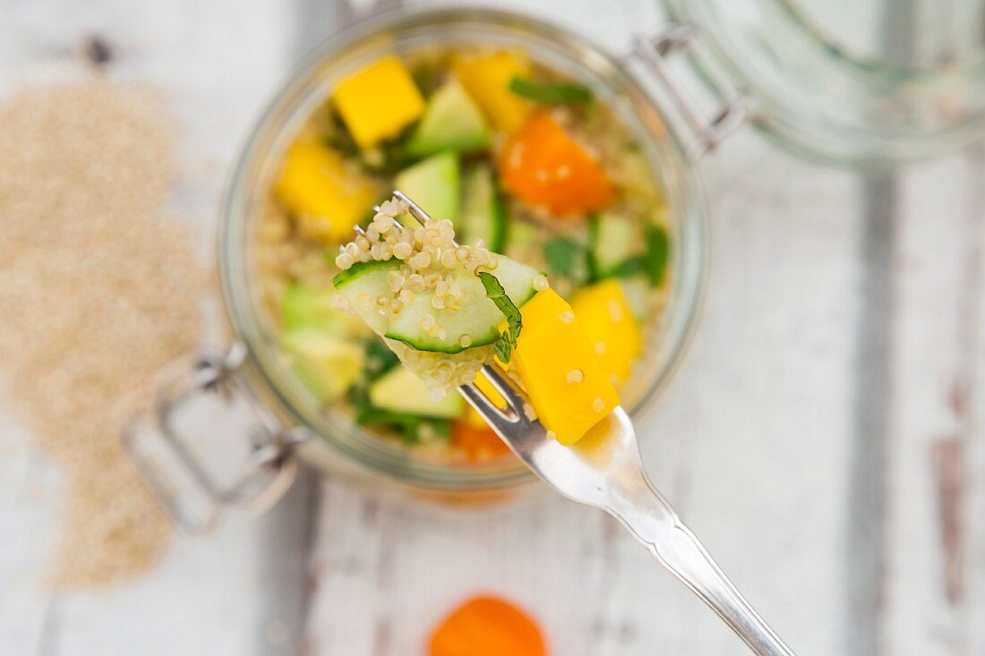 Quinoasalat mit Avocado, Gurke, Tomaten und Mango im Glas