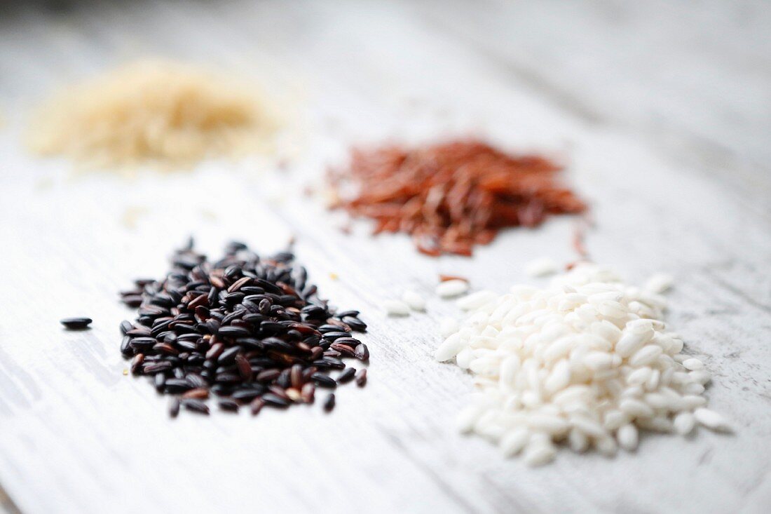 Four piles of different types of rice