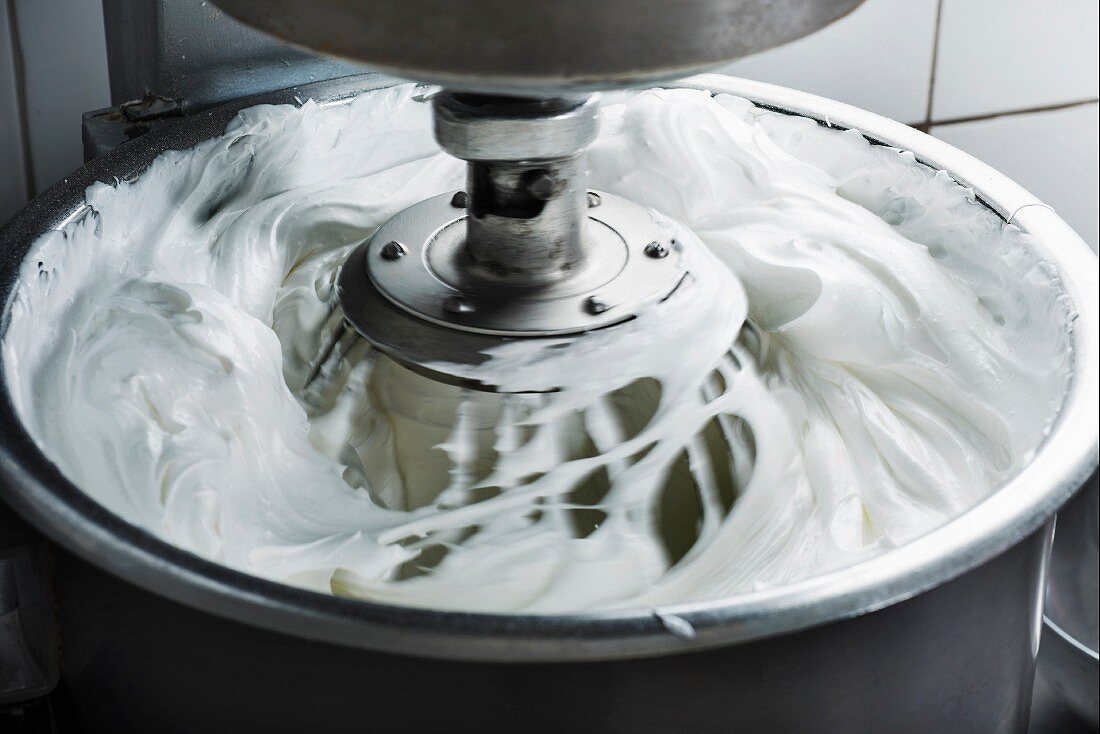 Egg whites being whipped in a mixer