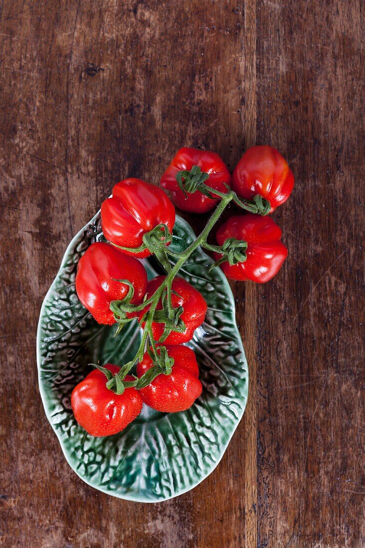 Small plum tomatoes in a ceramic bowl