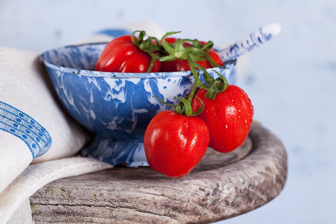 Small plum tomatoes in a ceramic bowl