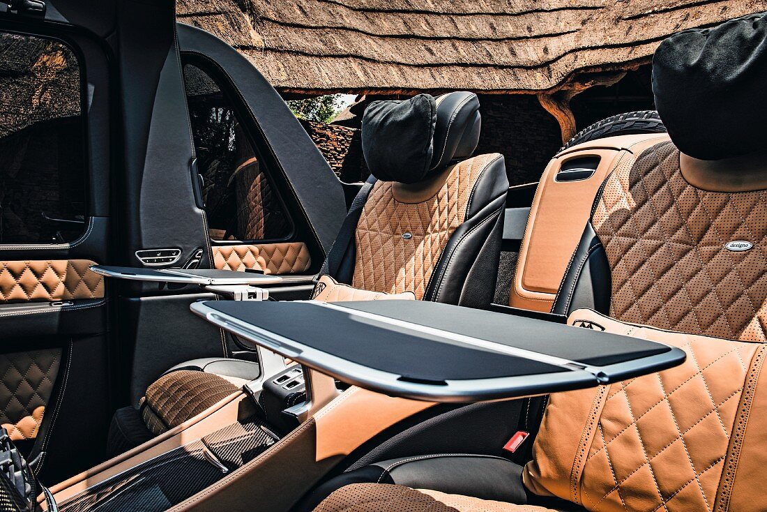 Backseats with tables in the Mercedes-Maybach G 650, an SUV by Mercedes, on safari in Africa
