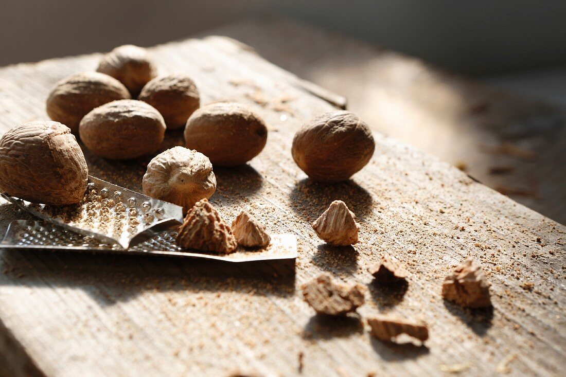 Whole and grated nutmegs and a nutmeg grater