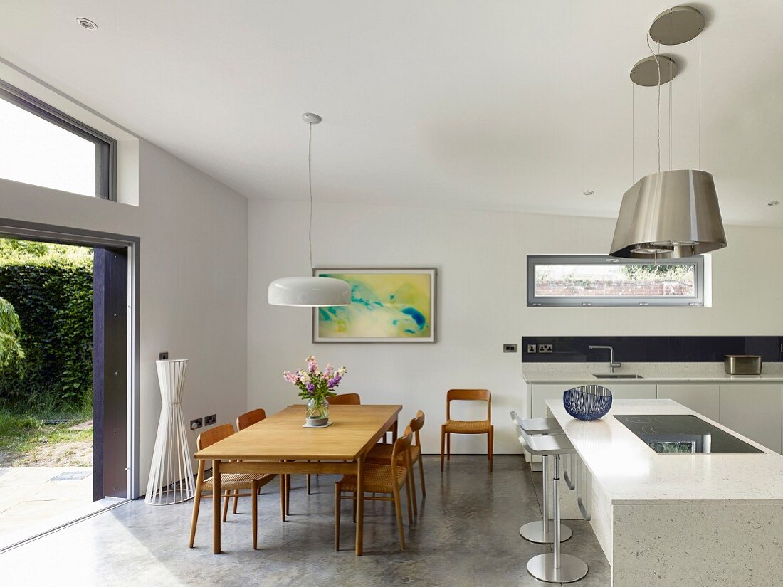 Dining set in open-plan kitchen with open sliding terrace doors