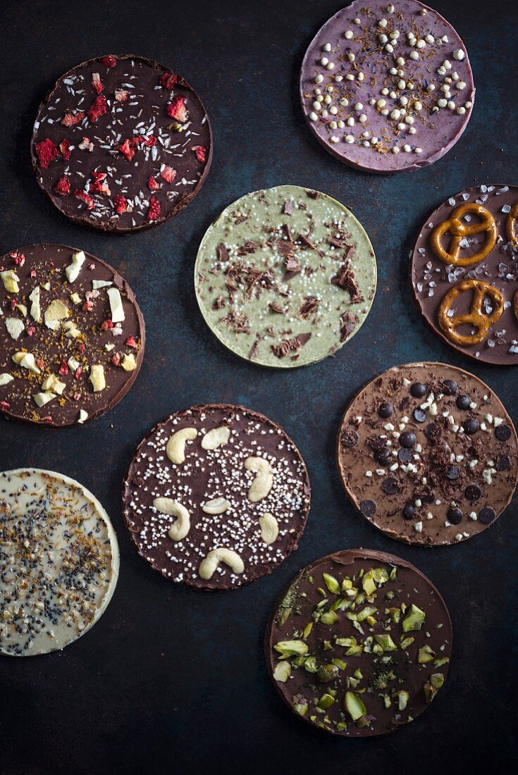 Vegan chocolate discs decorated with different toppings