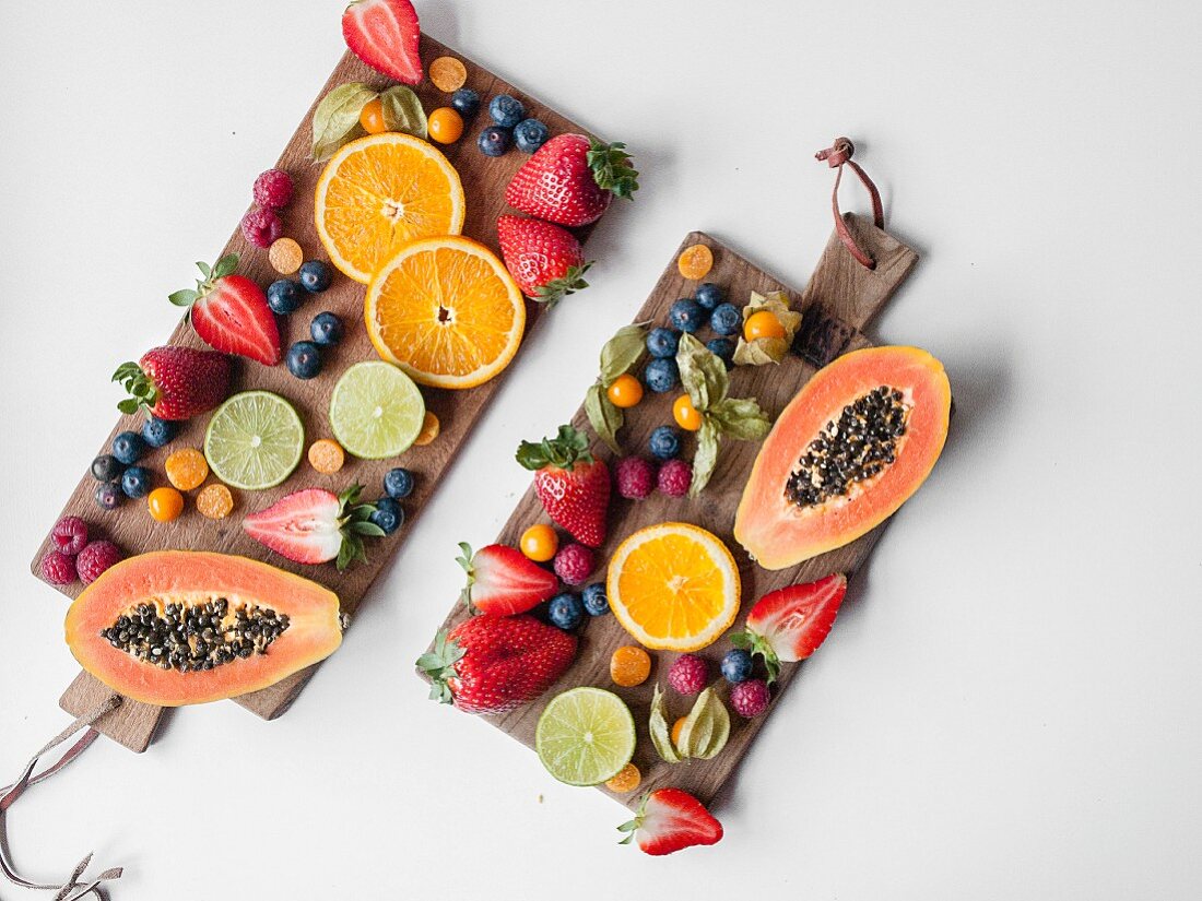 Fresh fruits arranged on two wooden boards (seen from above)