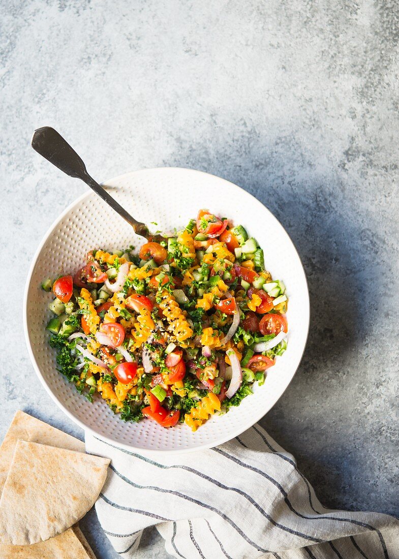 Pumpkin tabbouleh with tomatoes and parsley (top view)