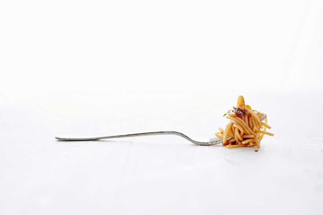 A Fork Full of Spicy Spaghetti Pasta With Anchovies and Garlic