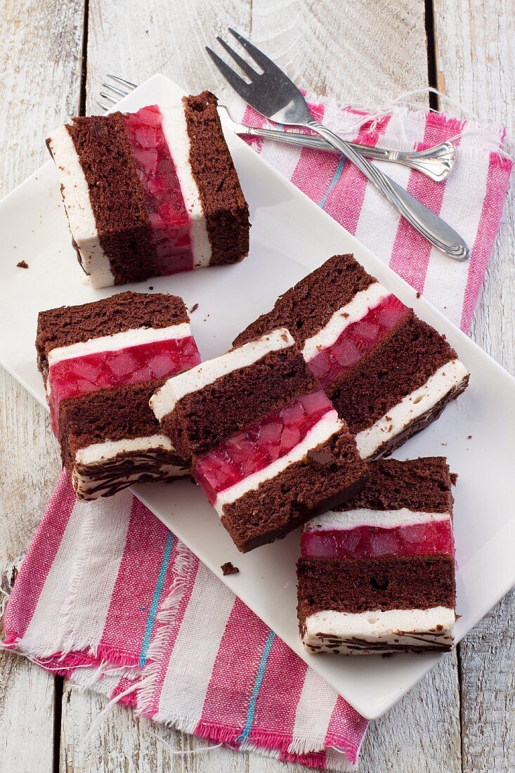 Chocolate cake with cherries jelly and creme