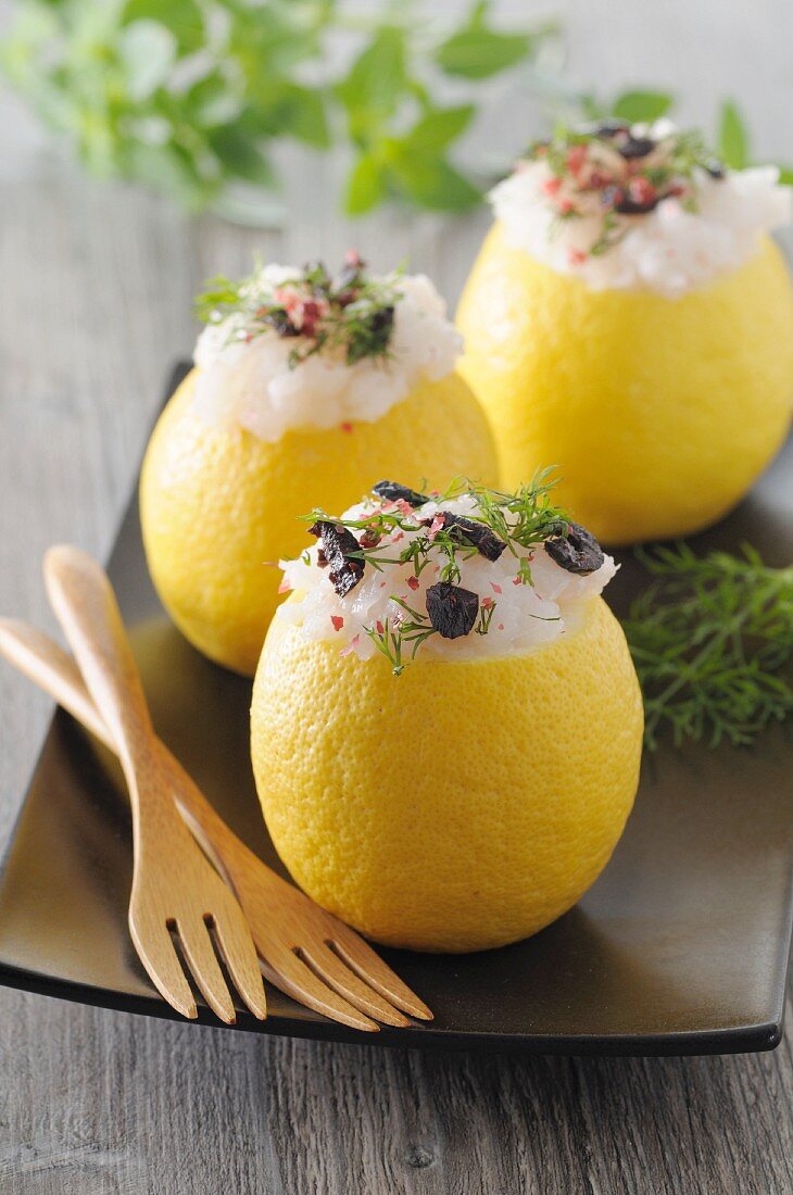 Lemons stuffed with cod, black olives and dill