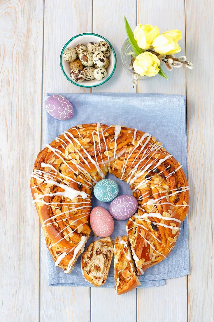 An Austrian yeast ring decorated with colorful eggs, quail eggs and tulips