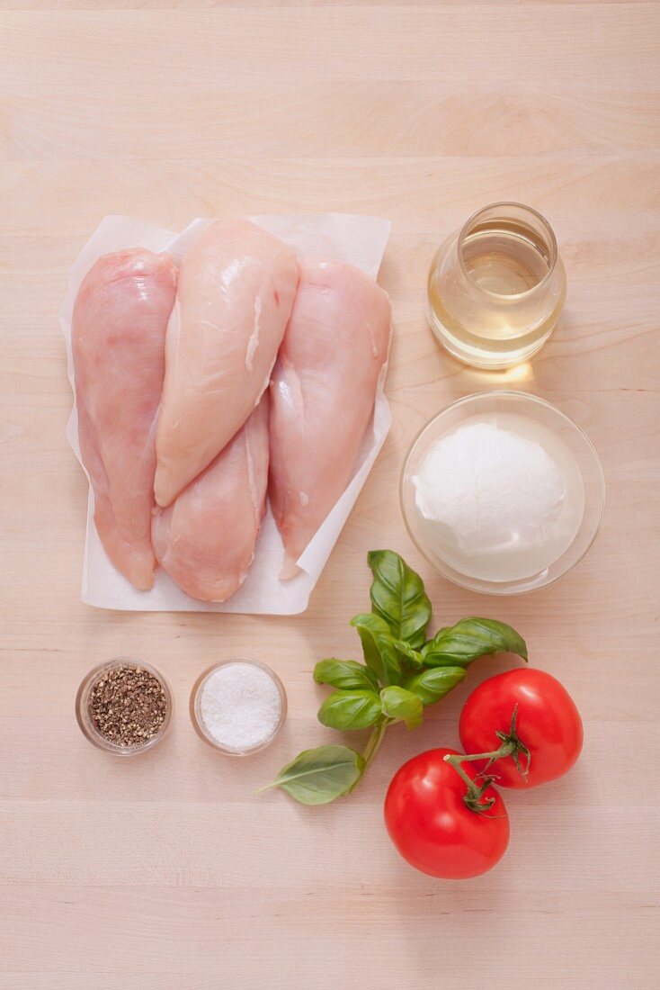 Ingredients for oven-baked chicken breast with tomatoes and mozzarella
