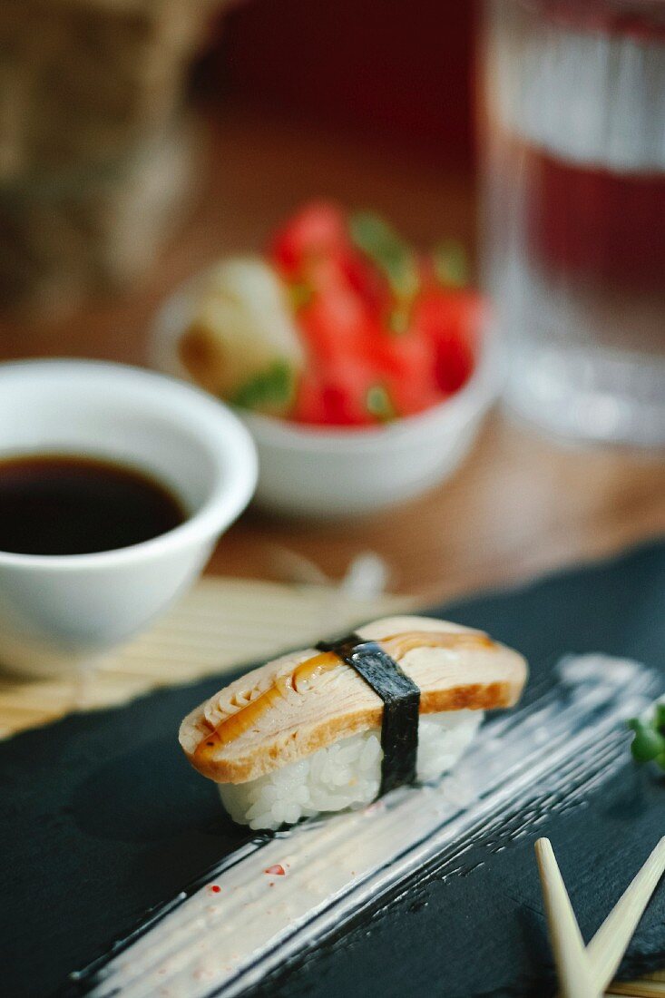 Nigiri sushi with omelette on a black plate