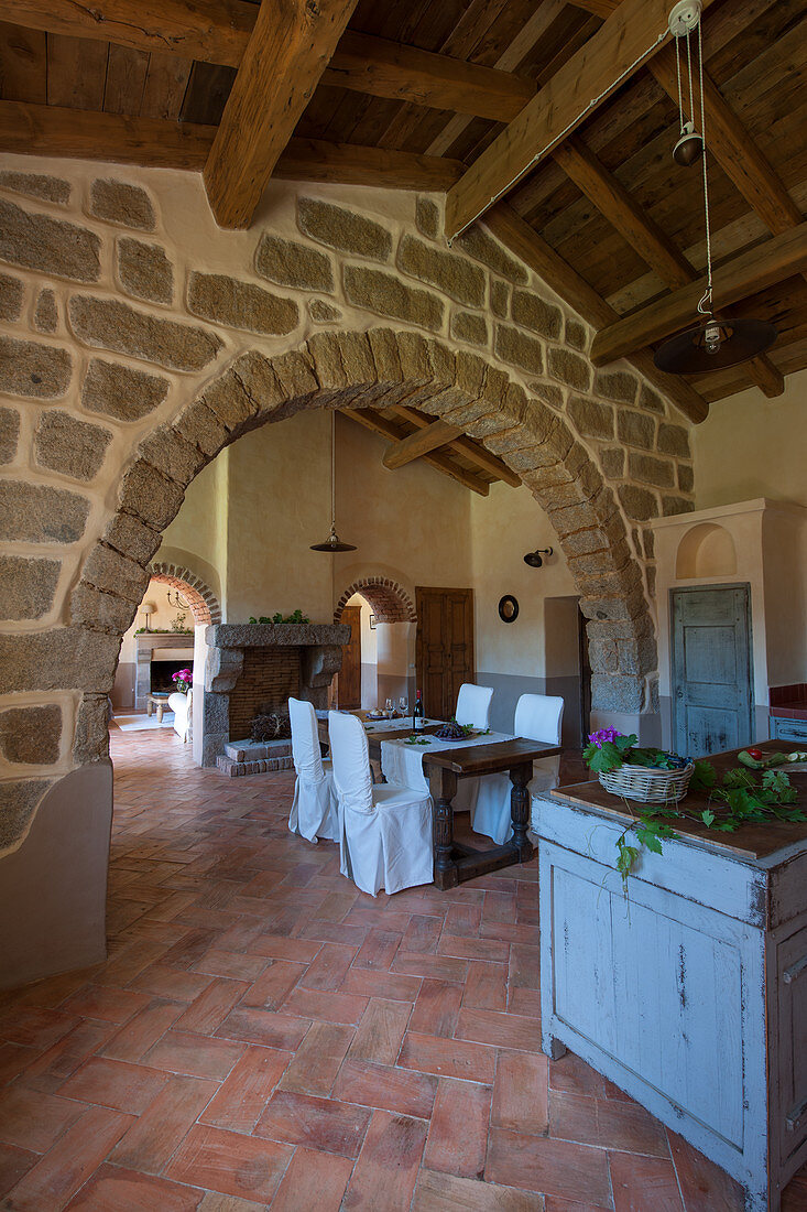 Open-plan interior in old Mediterranean house with stone arch